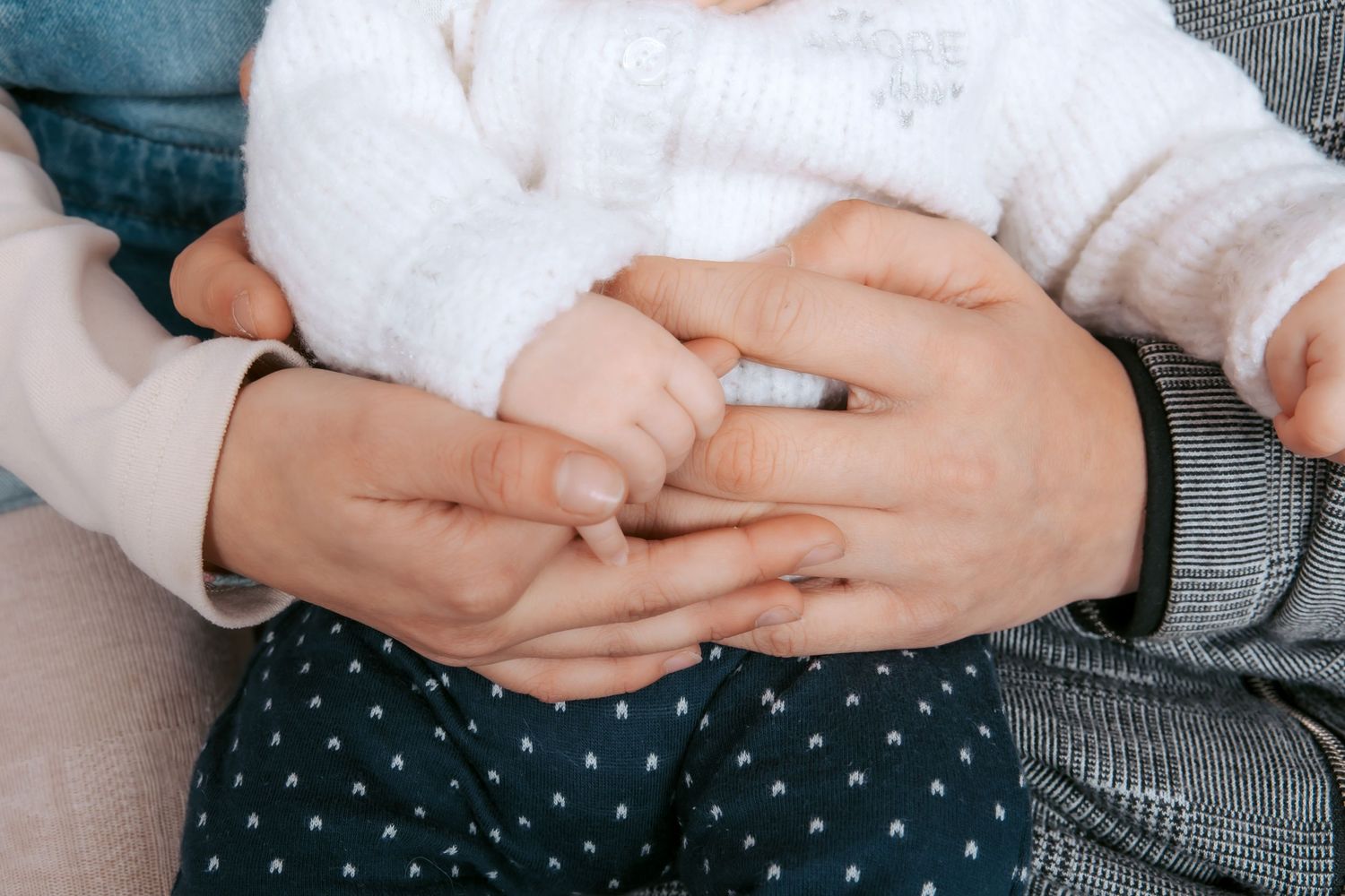 Close-up shots of gentle hands cradling a newborn baby.