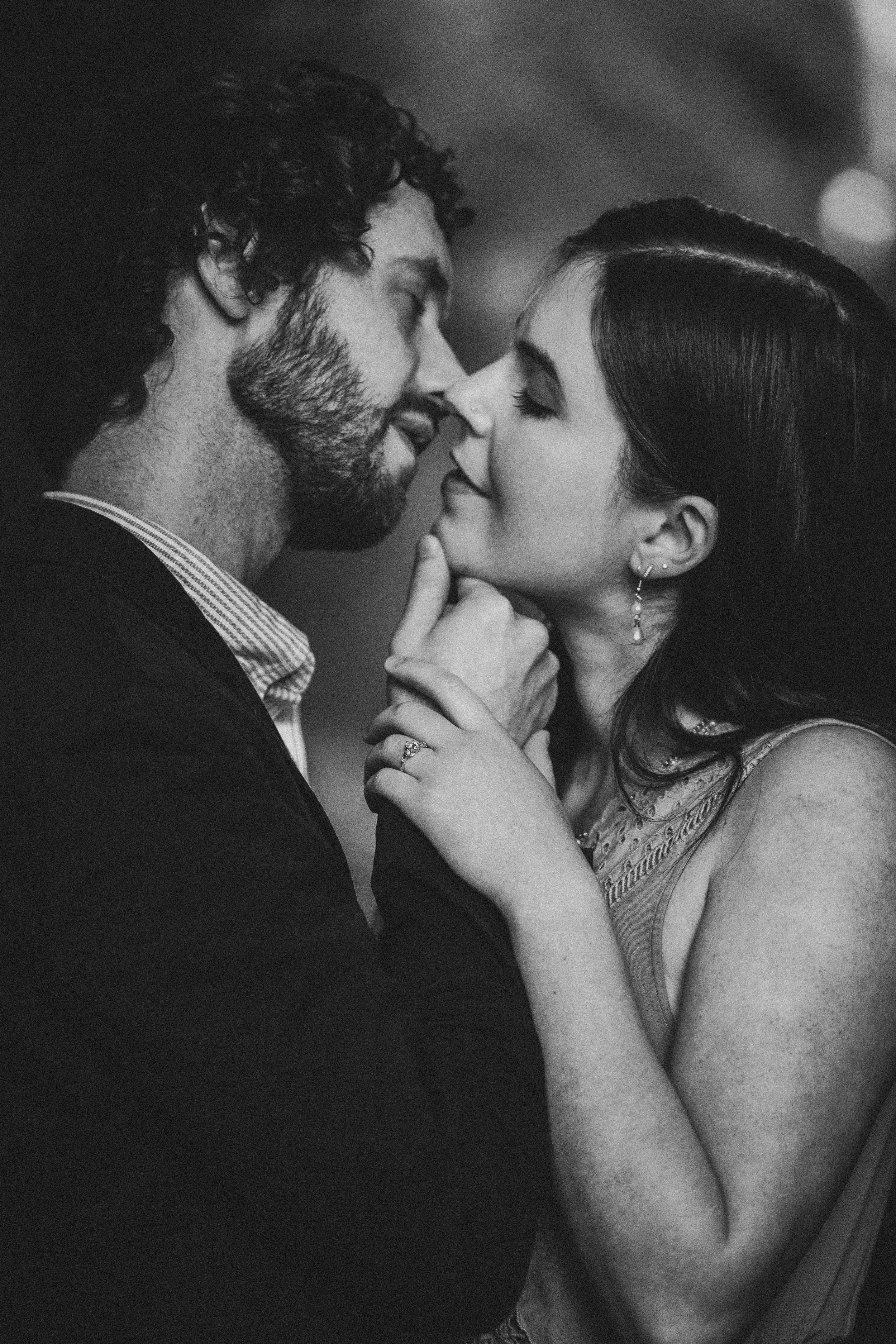 A series of black and white romantic photographs showing intimate moments between a couple in close embrace.