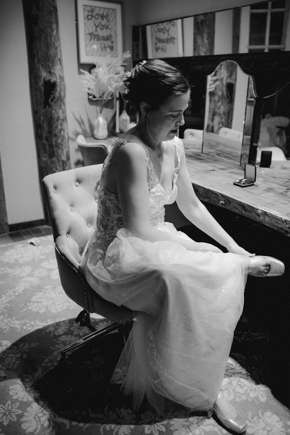 A series of black and white photos showing a bride in a flowing white dress seated at an elegant piano.