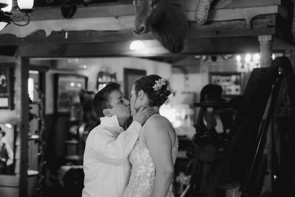 Guests dancing in a dimly lit reception venue with string lights overhead.