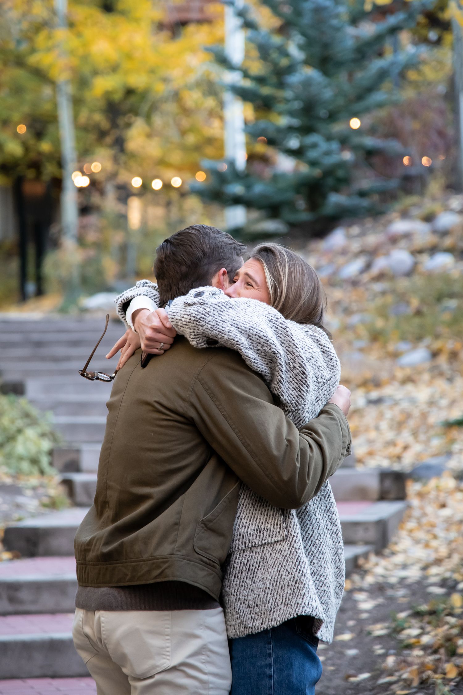 A cute couple hugs and reacts to a surprise proposal in Vail Colorado