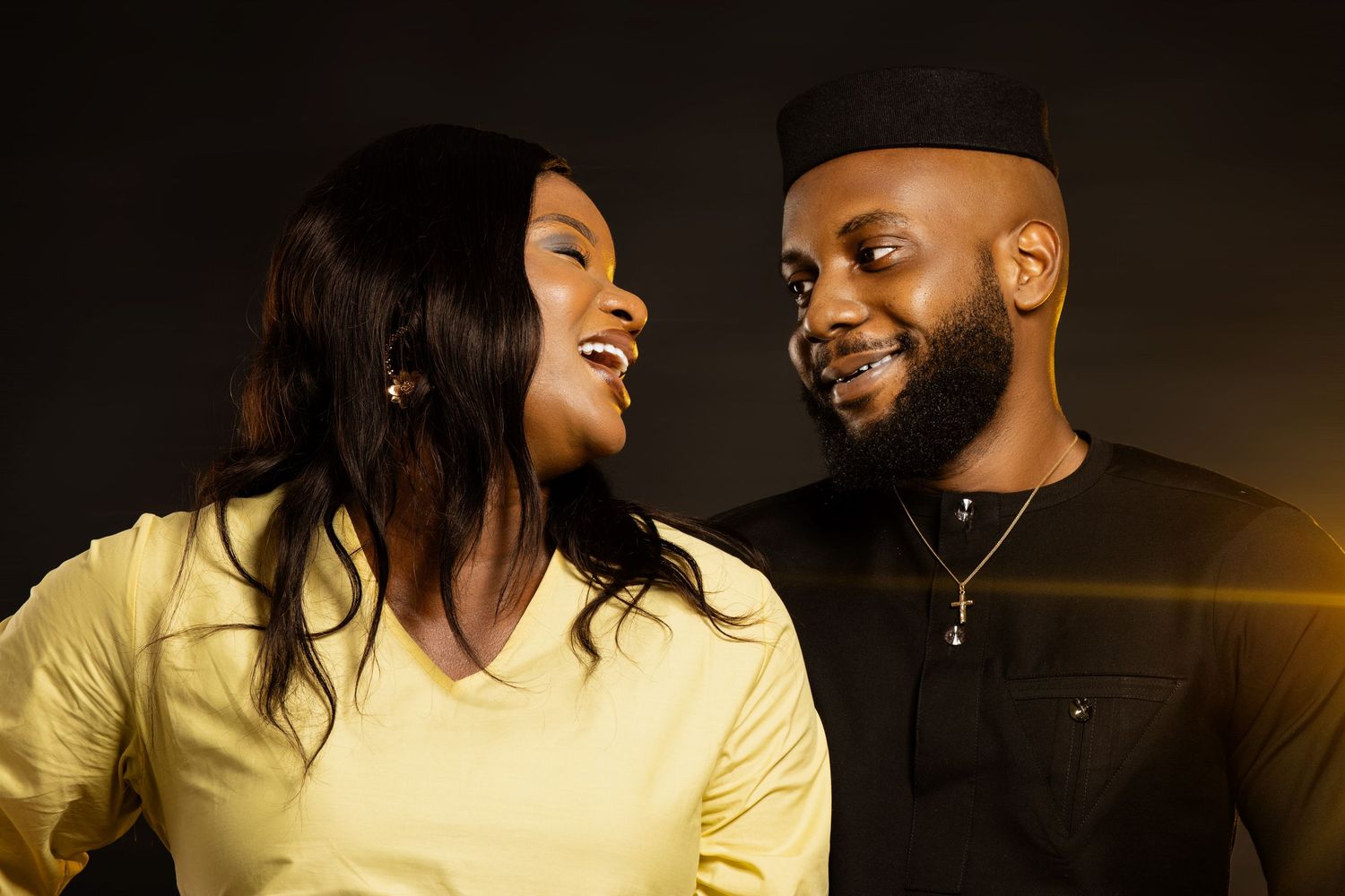 Intimate couple's portrait session with warm lighting and yellow tones.