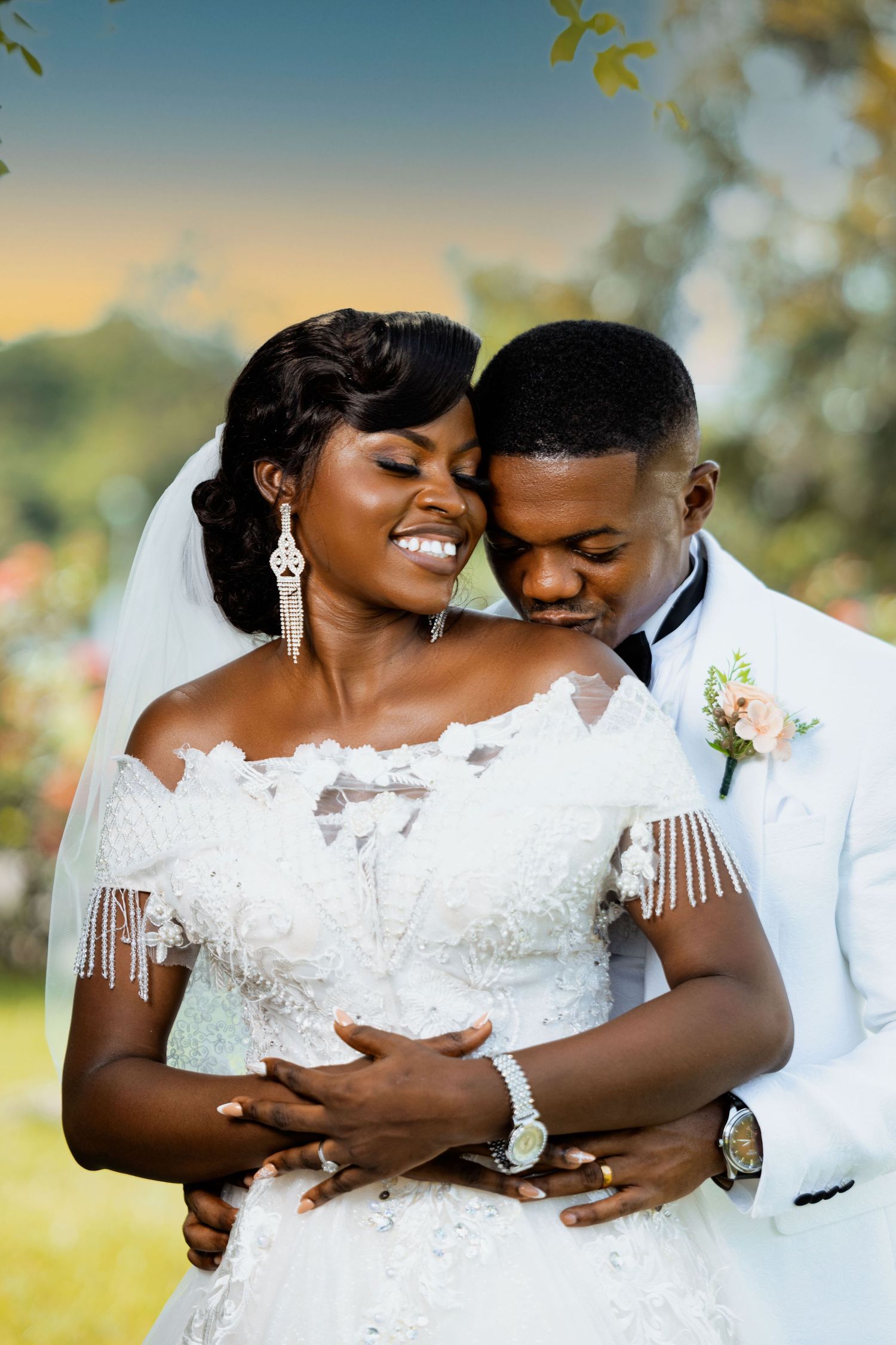 A joyful wedding portrait captured in a sunlit garden setting.