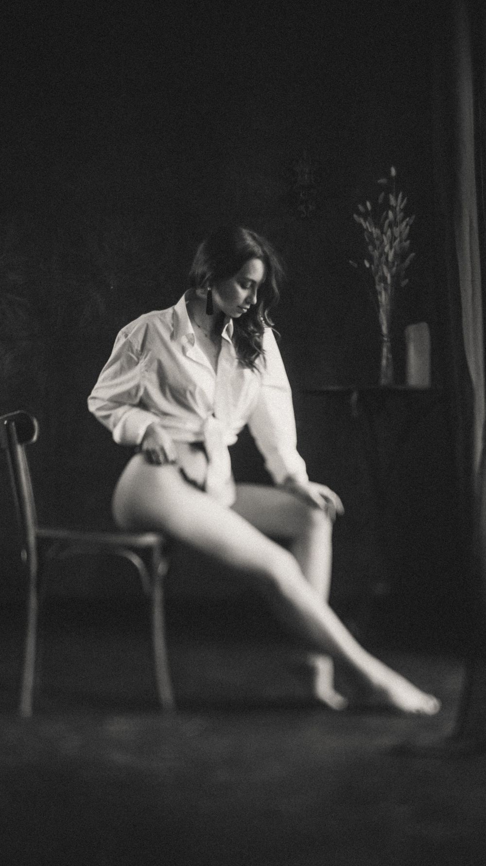 A dramatic black and white photo sequence shows a figure in white sitting in darkness near a chair.