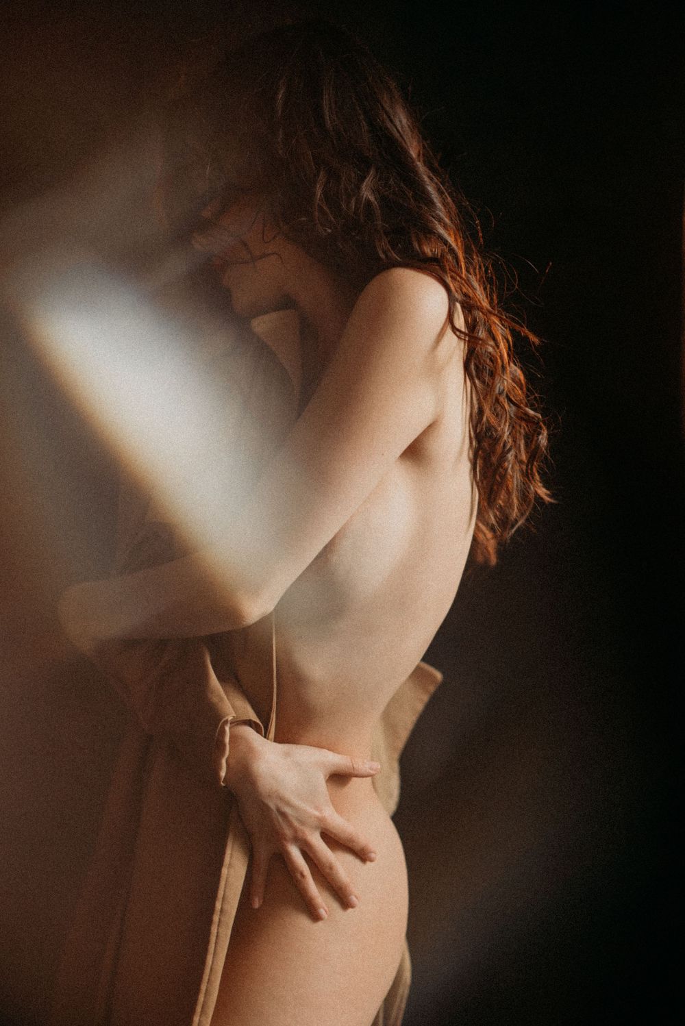 Artistic nude photography sequence showing shadows and light playing across bare shoulders and neck in moody lighting.