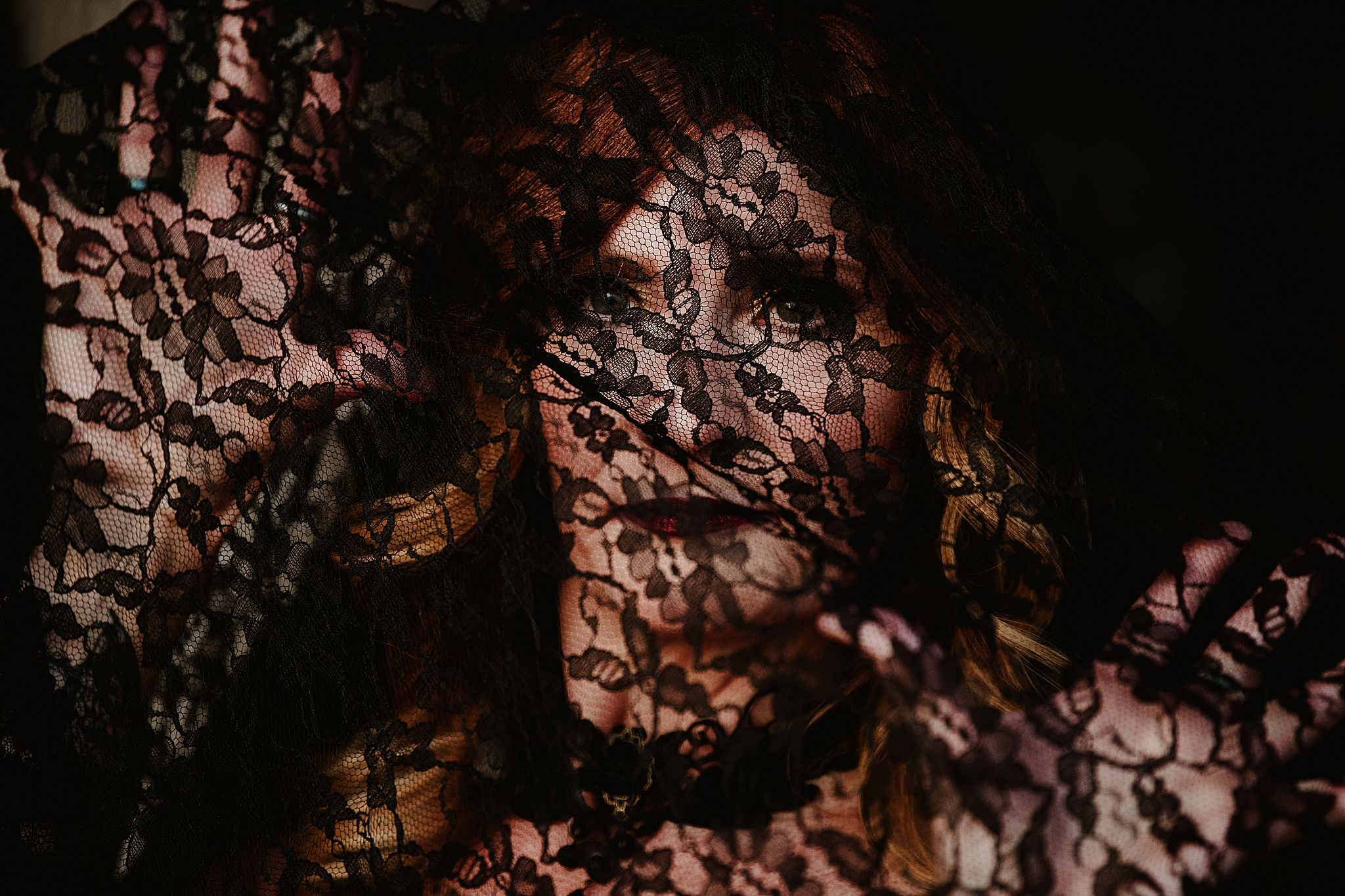 Aerial view of rocky terrain with dark shadows and rough textures creating an abstract pattern.
