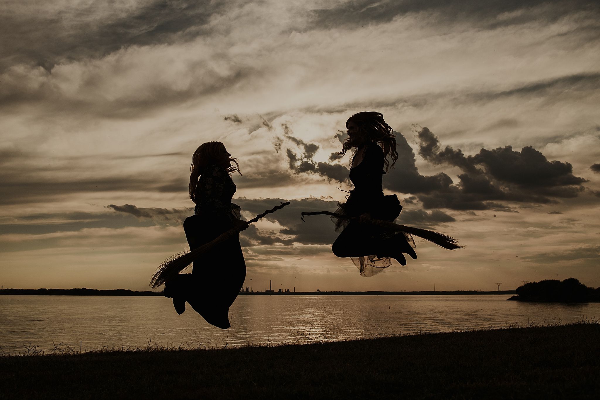Silhouetted figures jumping against dramatic cloudy sunset sky in sequence of action shots.