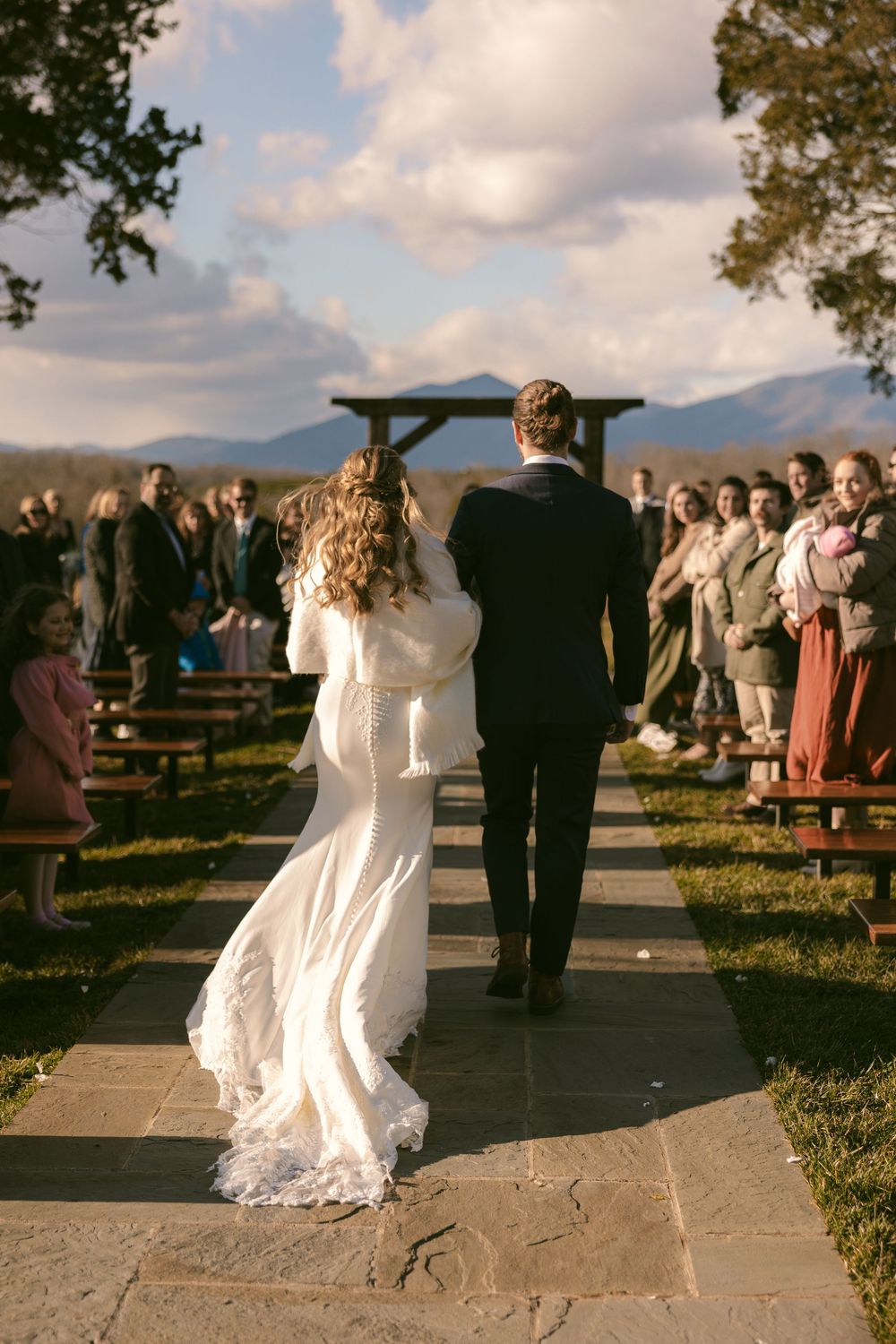 Brother walks his sister down the aisle during her wedding at Cedar Oaks Farm in Bedford, VA