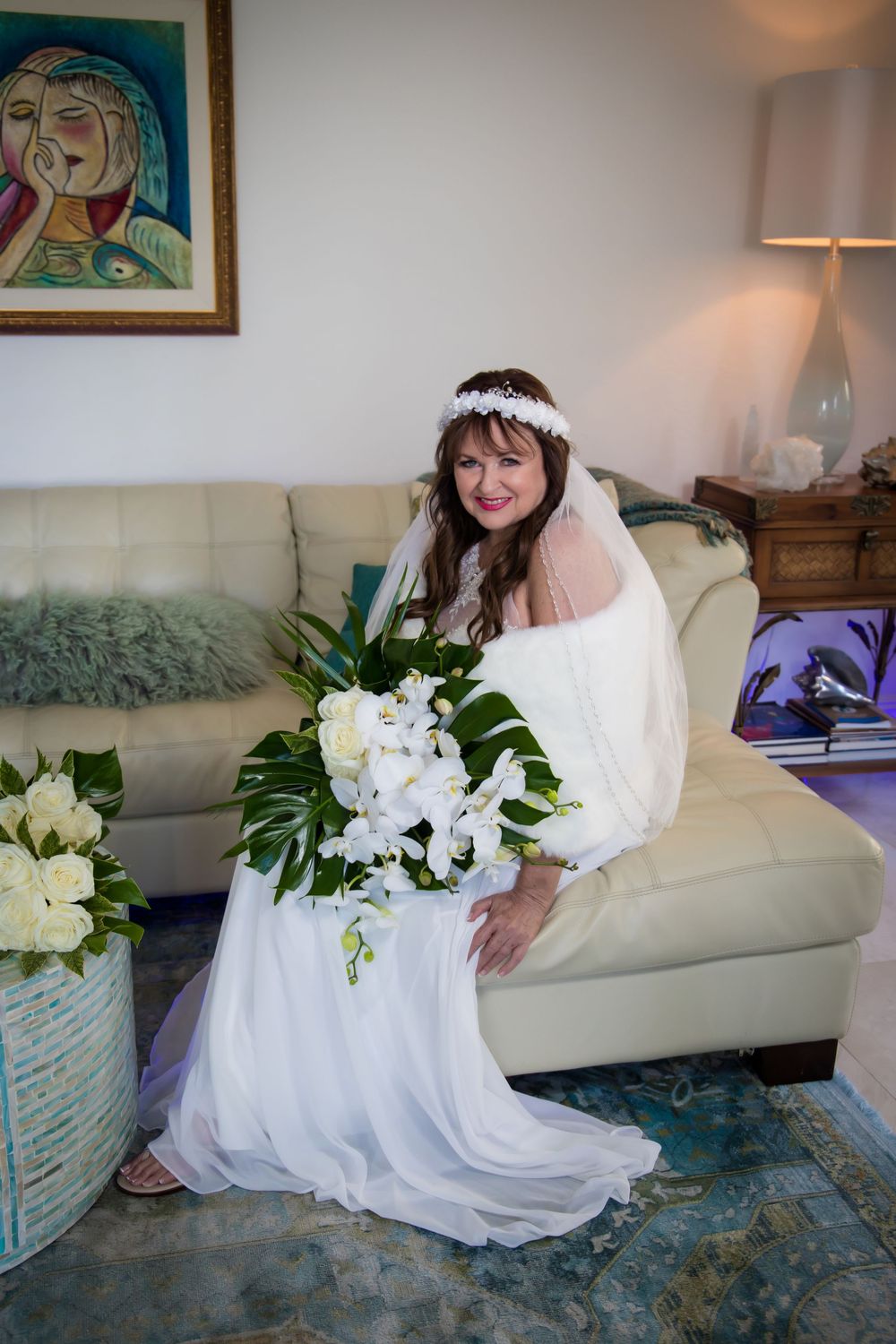 A series of photos showing a white wedding dress and bouquet of white flowers against a light blue couch.
