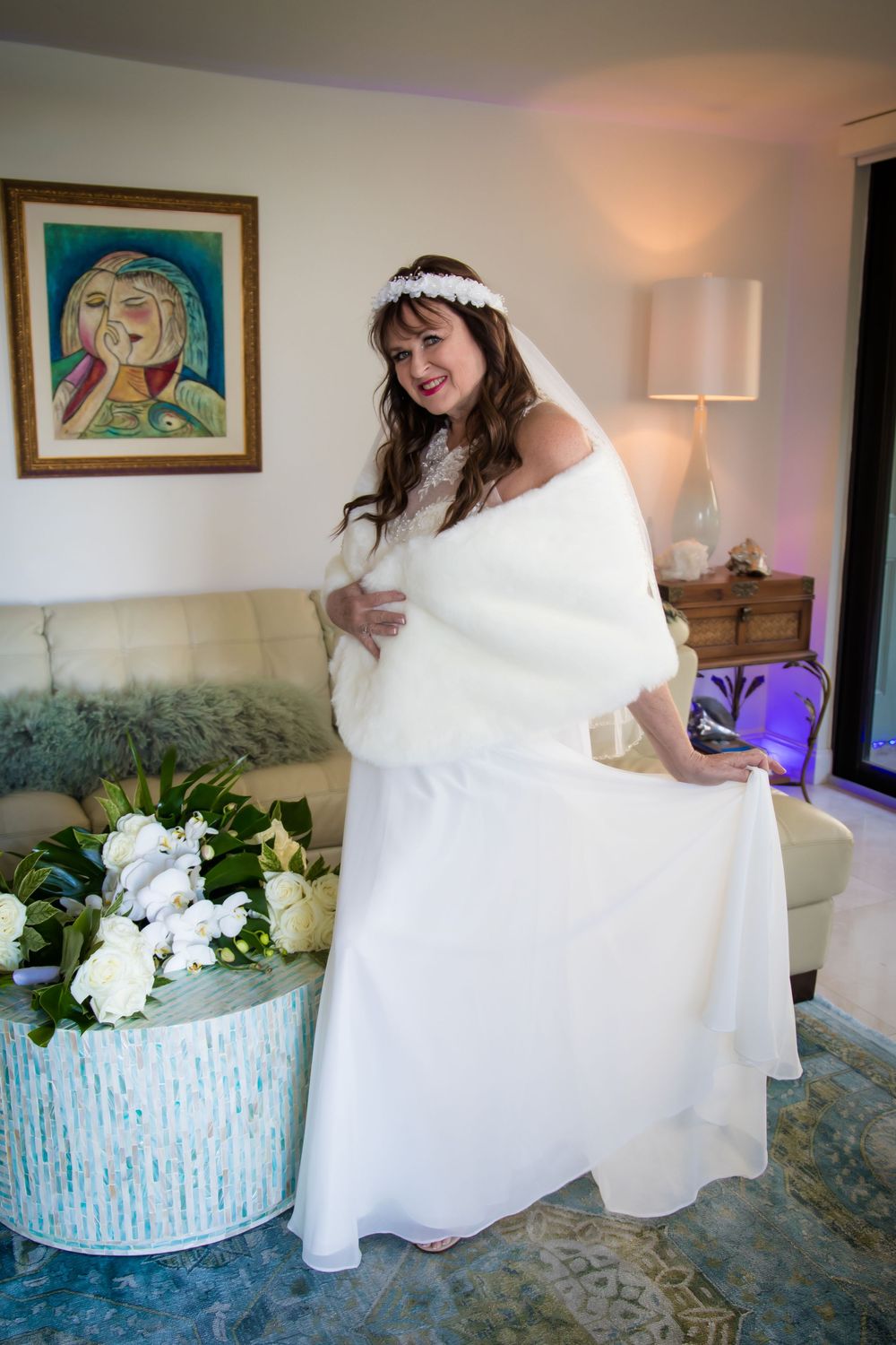 A series of photos showing a bride in a white wedding dress getting ready while sitting on a blue patterned couch.