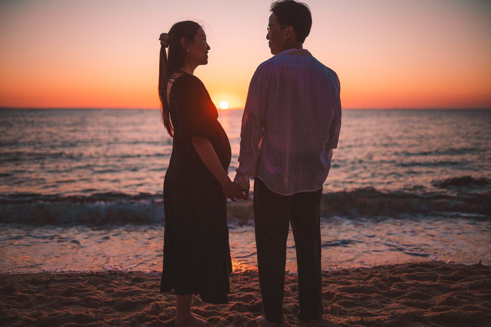 A beautiful sunset with a pregnant couple silhouette taken by a Melbourne maternity photographer.