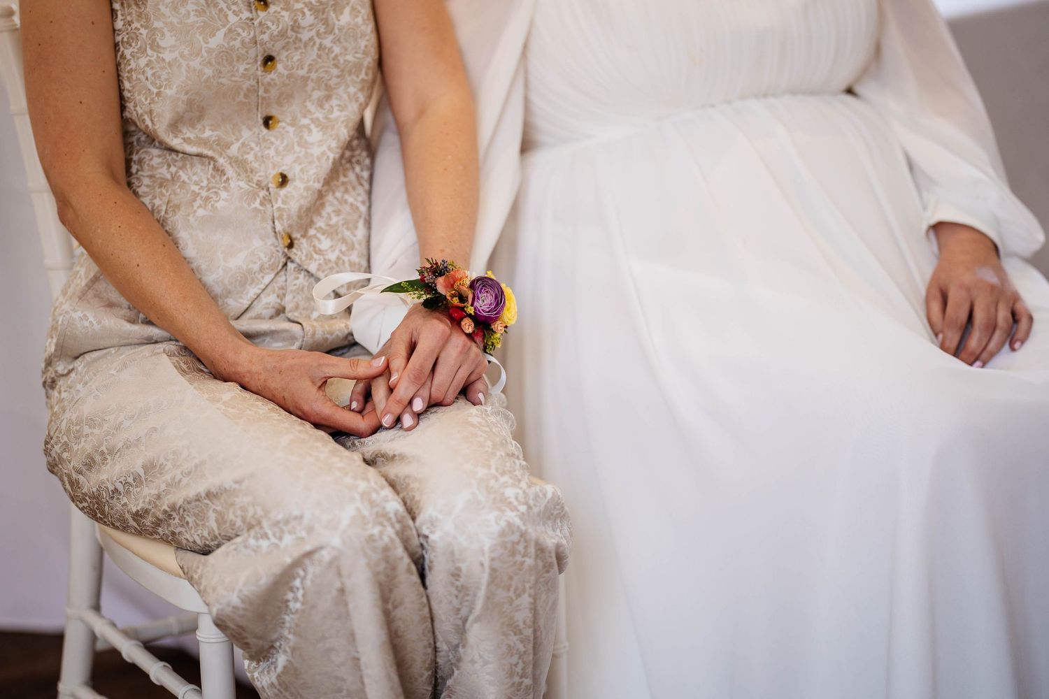 two brides holding hands during their celebrant led ceremony at The Hope Street Hotel in Liverpool captured by LGBTQ+ wedding photographer