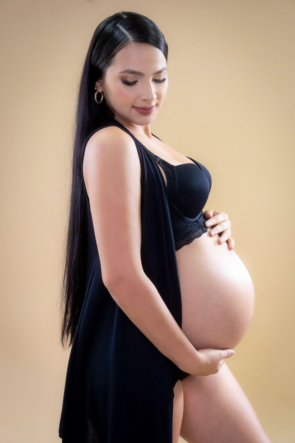 Fotografía de embarazo en Valledupar con vestido elegante, retratos maternales llenos de luz y emoción en Cesar.
