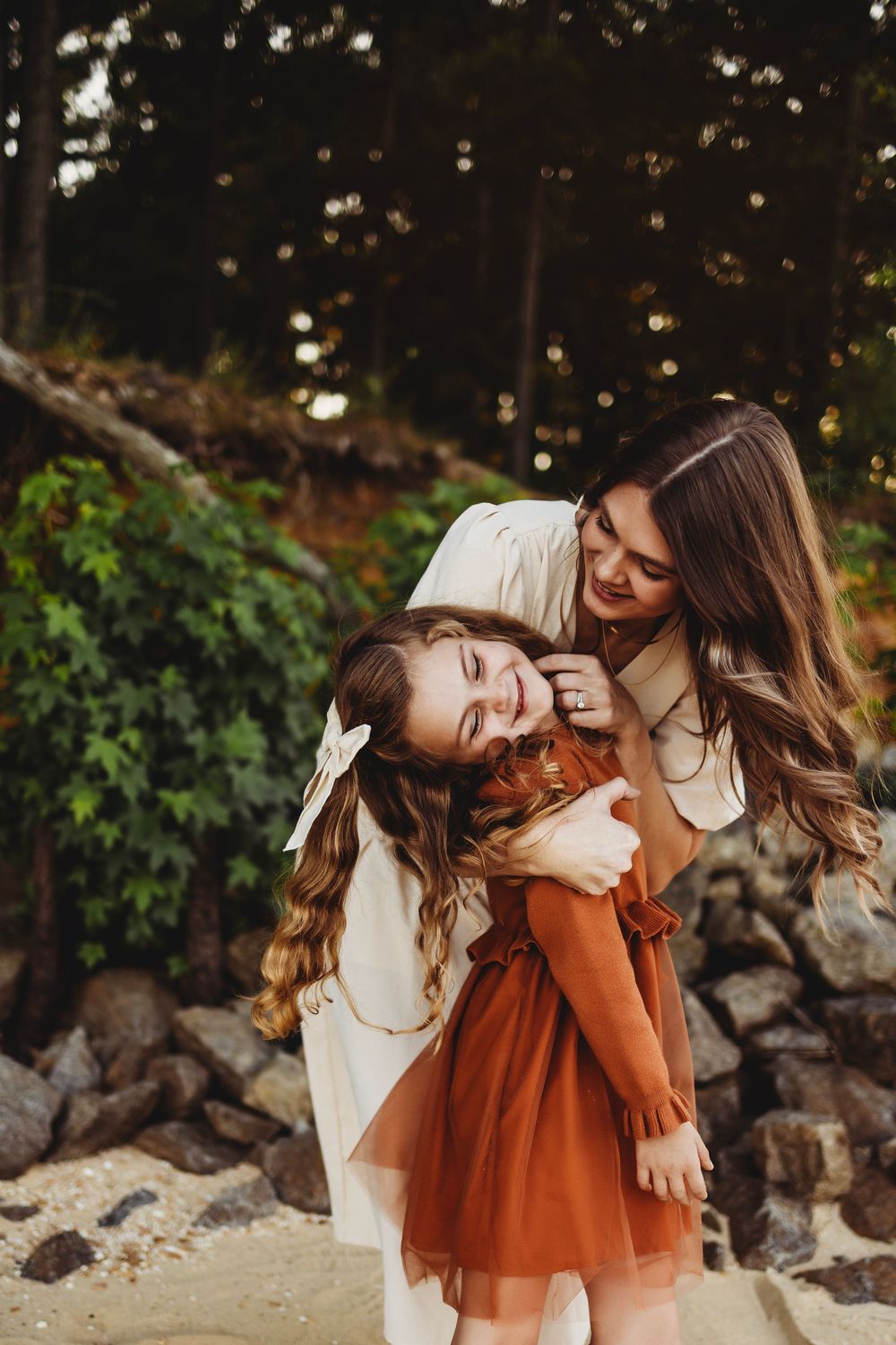 A joyful moment captured outdoors with bokeh lights and natural scenery in warm autumn tones.