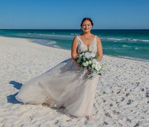 A beautiful beach wedding scene with white sand and turquoise waters providing a stunning natural backdrop.