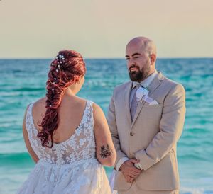 A beach wedding ceremony with turquoise ocean waters in the background.