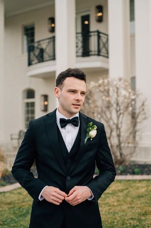 Formal event setting at an elegant venue with white columns and balconies in background.