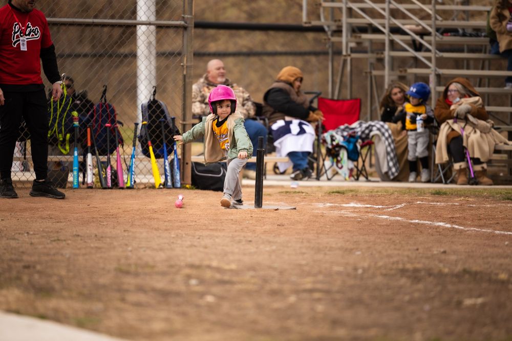 Throwing the bat at little league game to run to first base. Sports photography by Memorari Portrait in Albuquerque, New Mexico