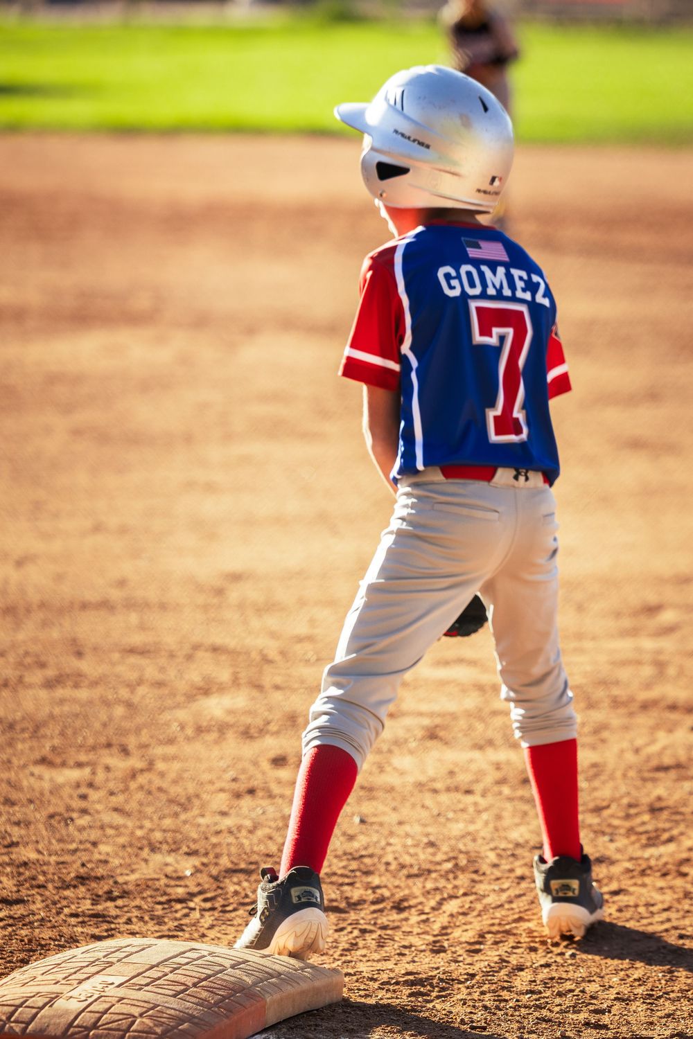 New Mexico Little League batter preparing to run from first base to second base. Sports photography by Memorari Portrait