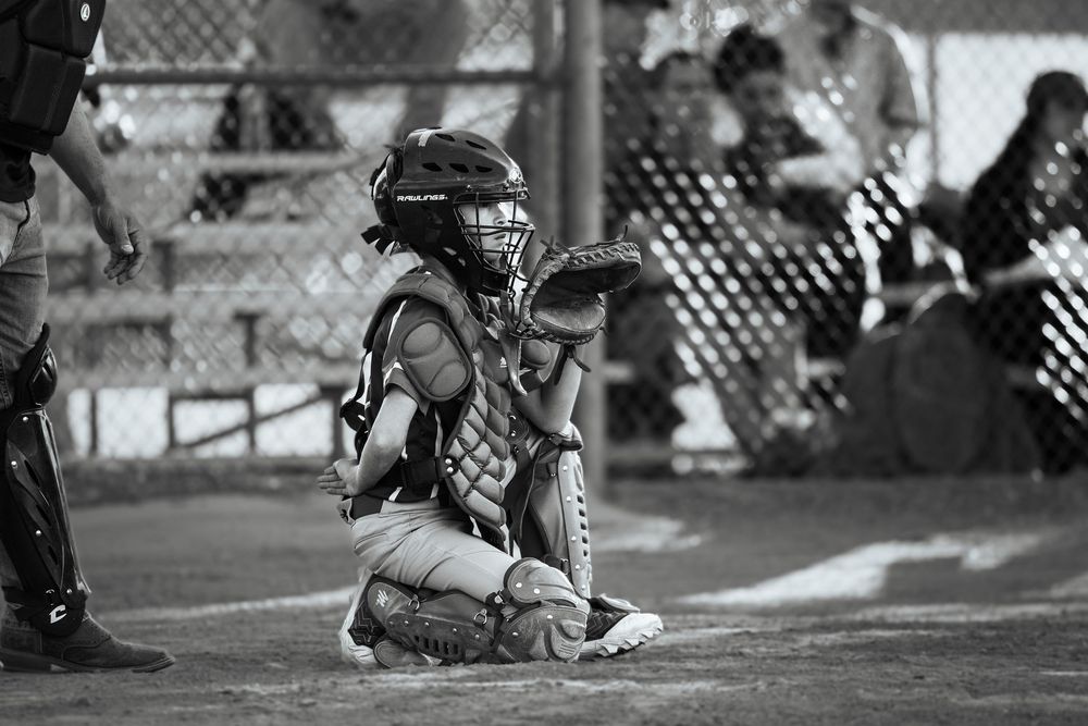 Little League Baseball photography in black and white, pictured is the catcher awaiting the pitch at Petroglyph Little League.