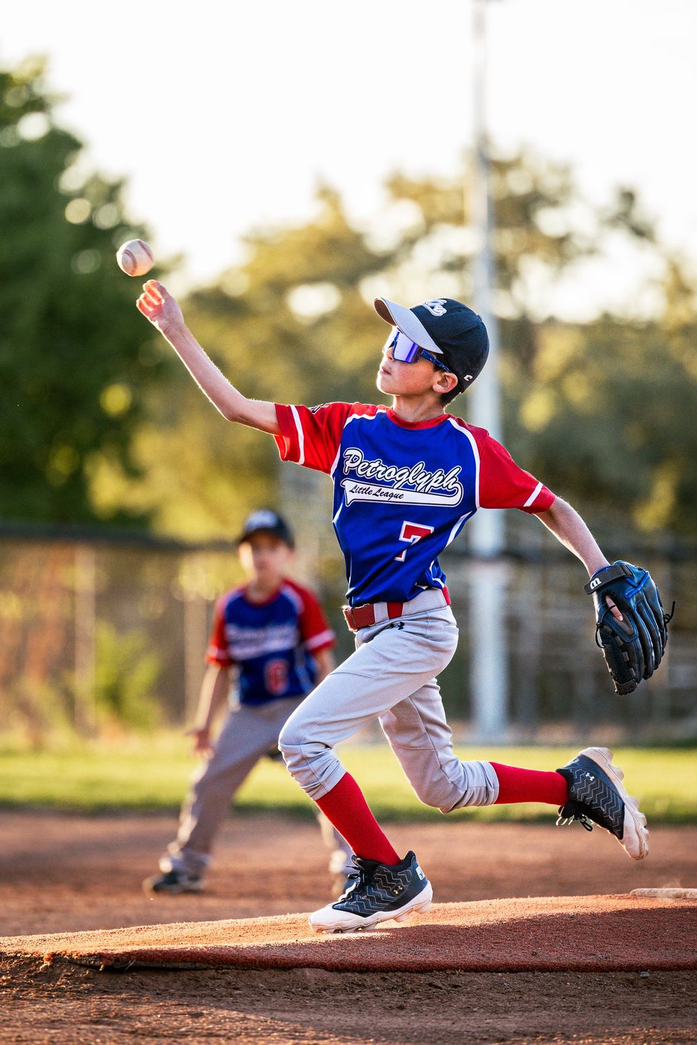 Little League Baseball in Albuquerque New Mexico. Pitcher throwing the ball at end-of-season game