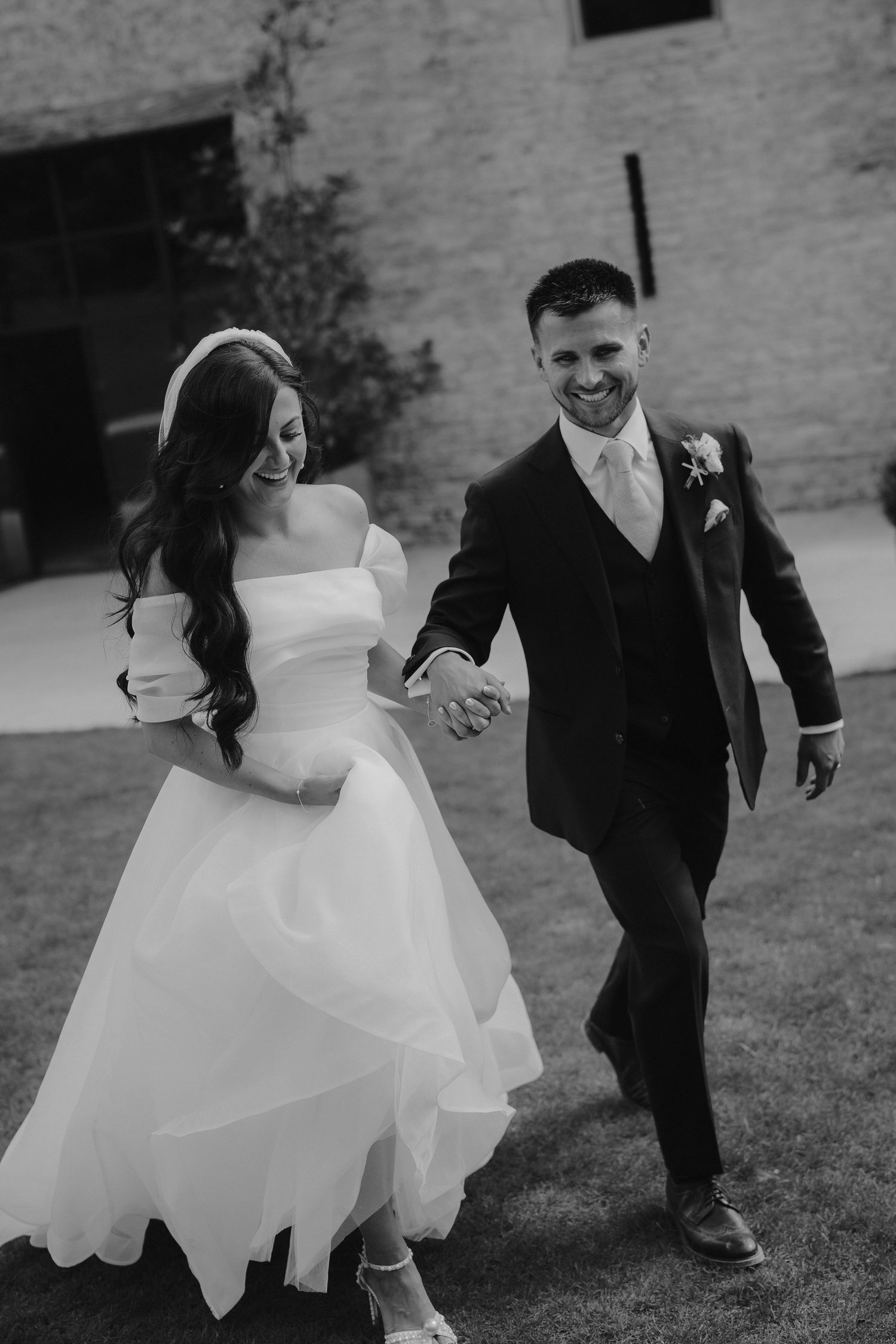bride and groom walking away from barn at yardspace old gore in cirencester