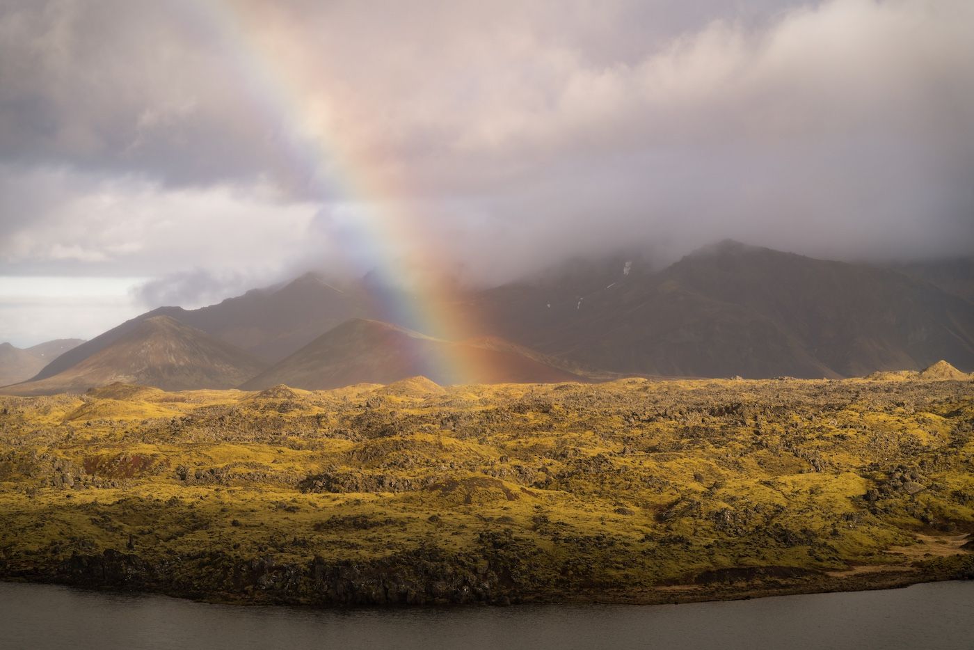 Rainbow over lava landscape