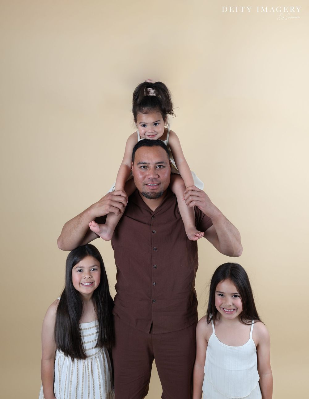 A series of four photos showing a playful family sequence in brown and white clothing against a beige background.