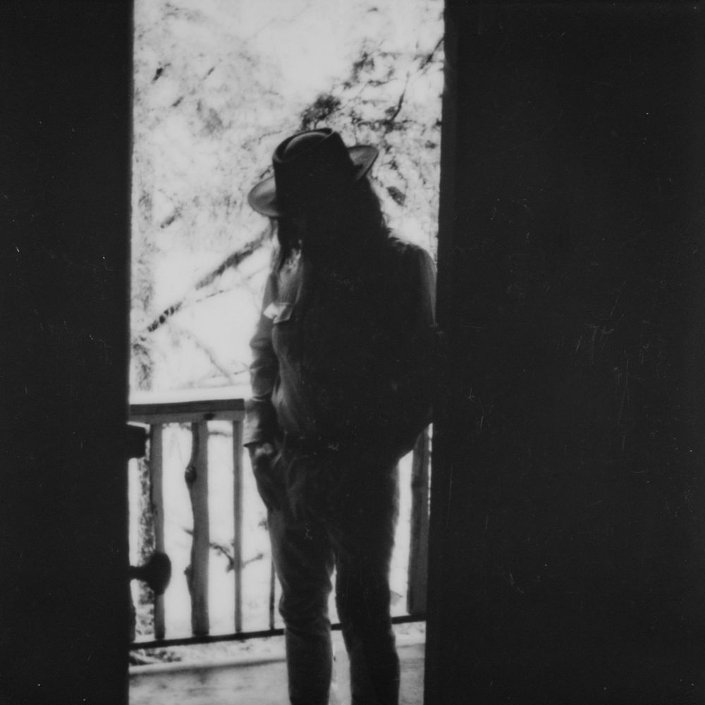 Moody black and white silhouettes against a bright window backdrop.
