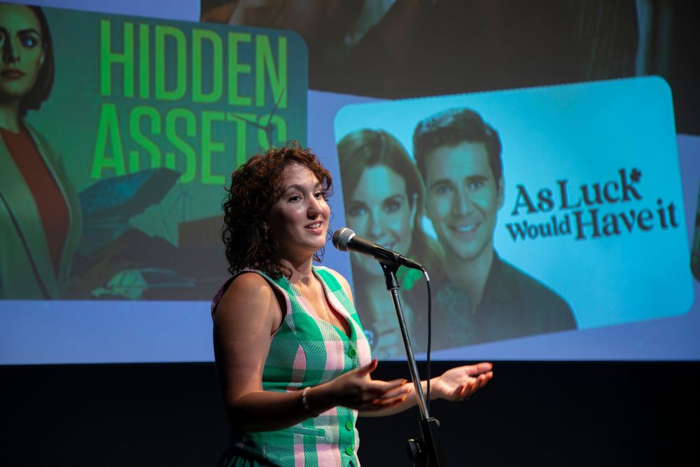 Theater performers on stage with a green and blue lighting setup perform during a live show.