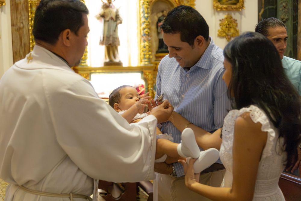 Religious ceremony taking place in a church with clergy member and participants.