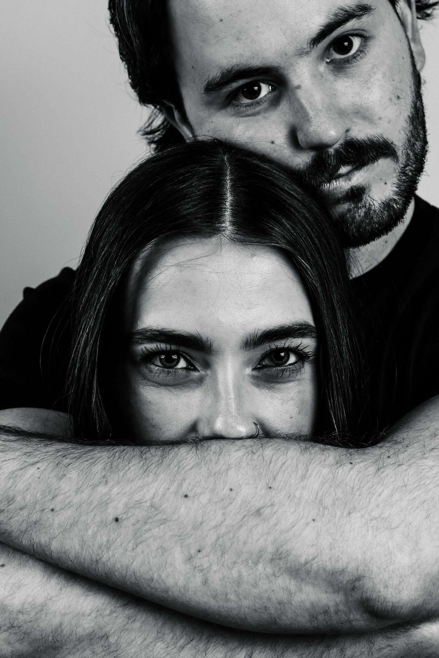 Black and white artistic photo series showing close-up intimate portraits with dramatic shadows and partial faces.