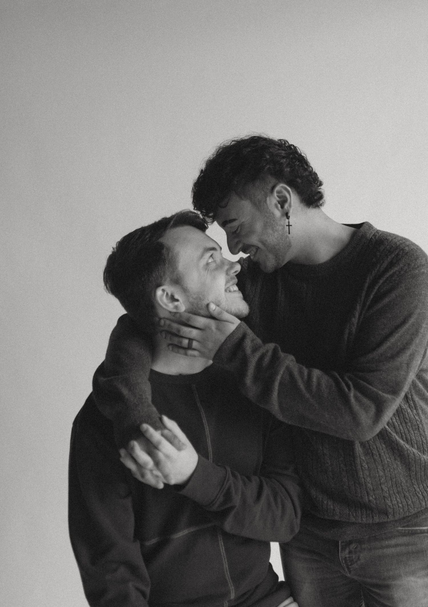 Intimate black and white portrait series showing playful interaction between two people.