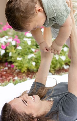 mother holding son and smiling at him