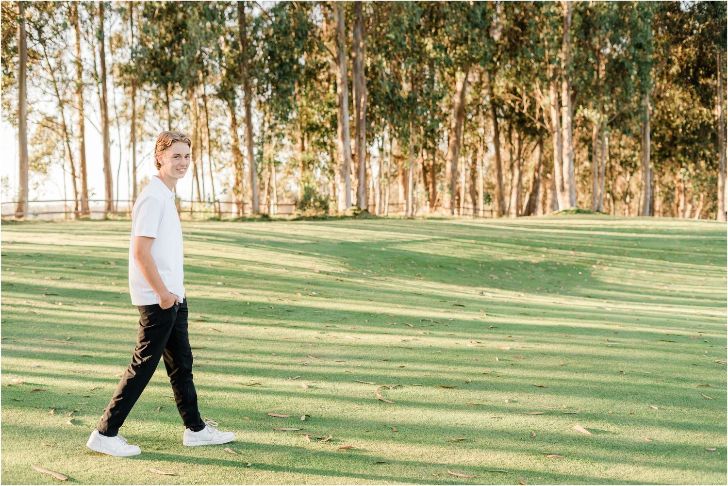slo high senior photo session | senior guy walking on golf course during senior session with felisha connolly photography | senior photos