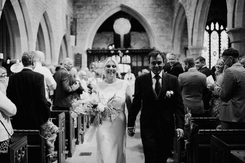A series of black and white wedding ceremony photos showing guests and couples in a church setting.