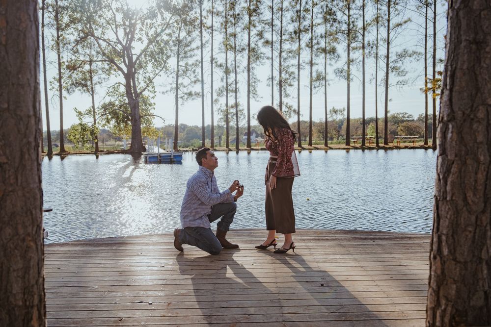 Proposal moment captured on wooden dock by lake.