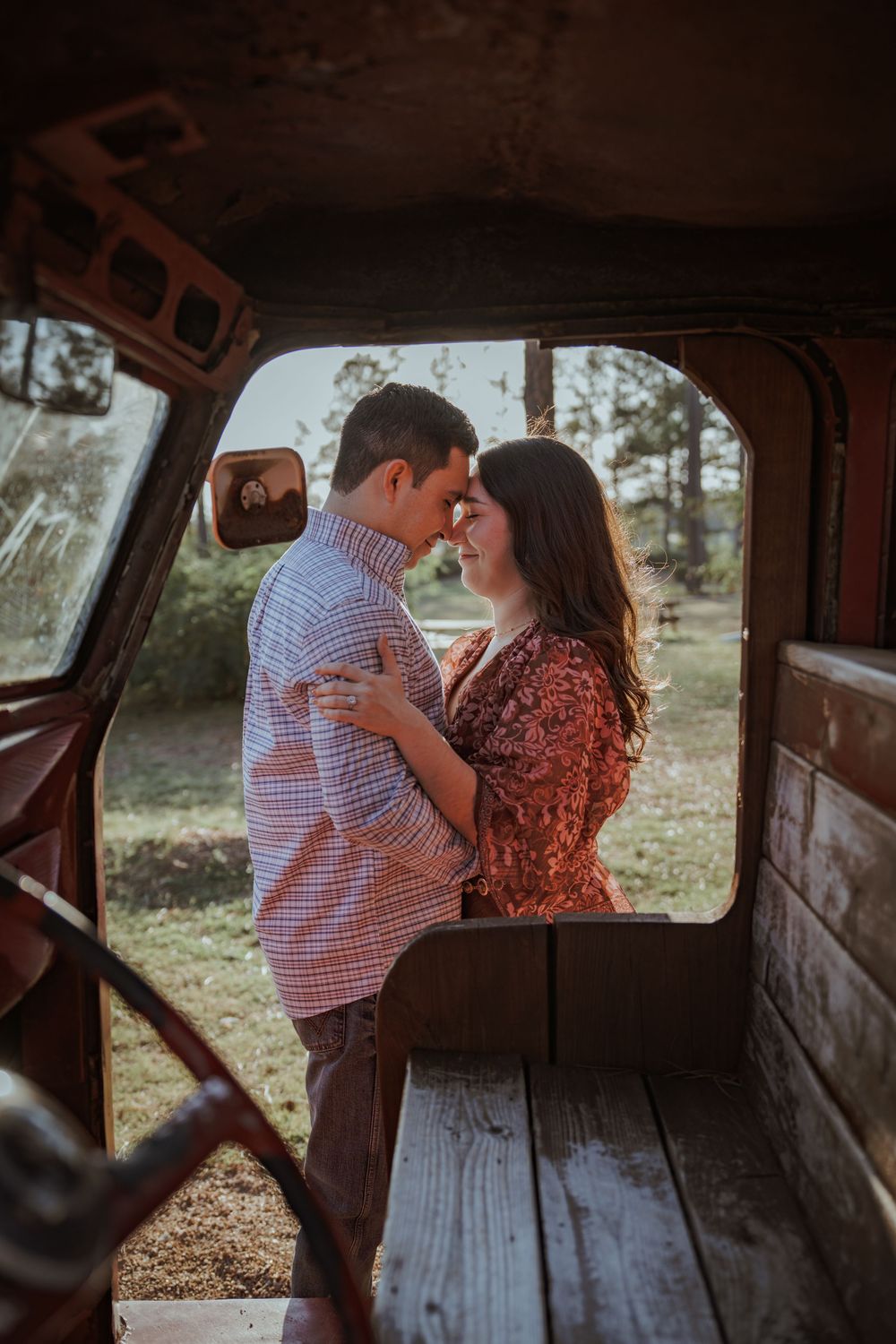 A romantic moment shared inside a vintage truck bed during a photo session.