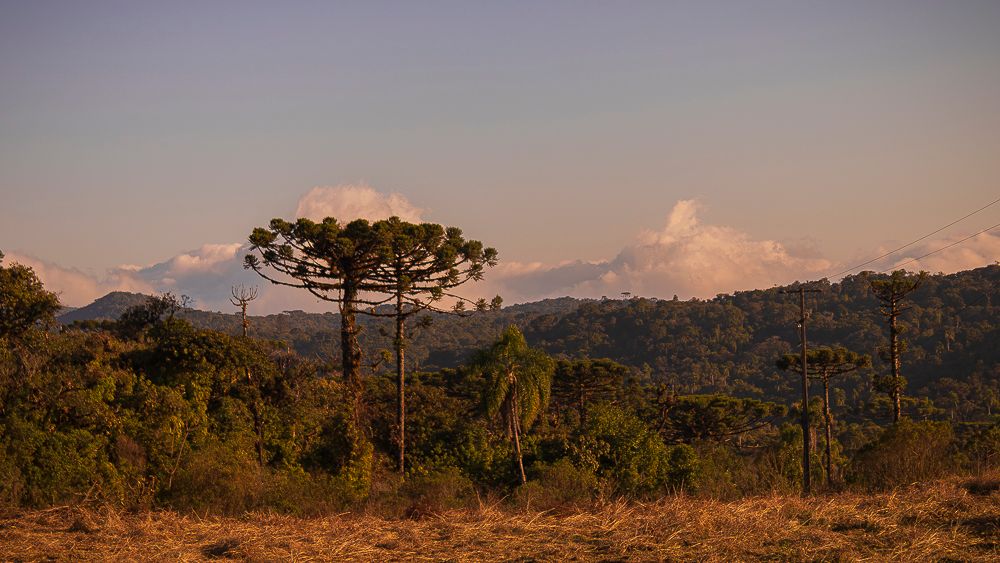 Mountain landscape with clouds and distant hills at sunset by Piret Victoria Ribas.