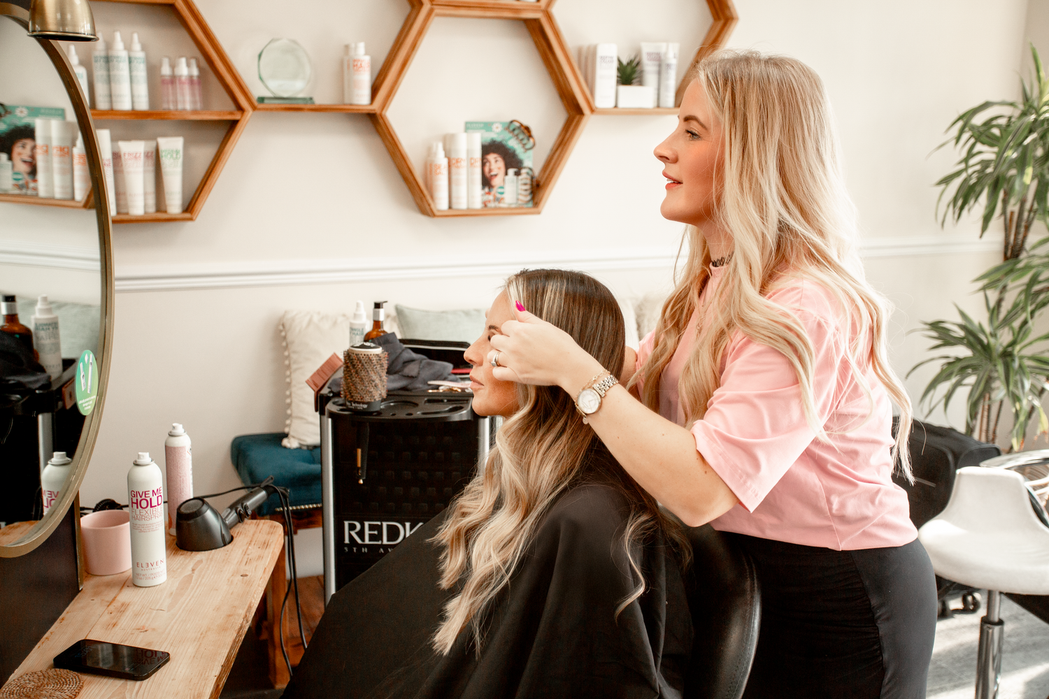 Professional hair styling session in modern salon with hexagonal mirrors.Salon Branding Photography in St Austell, Cornwall - Caribou