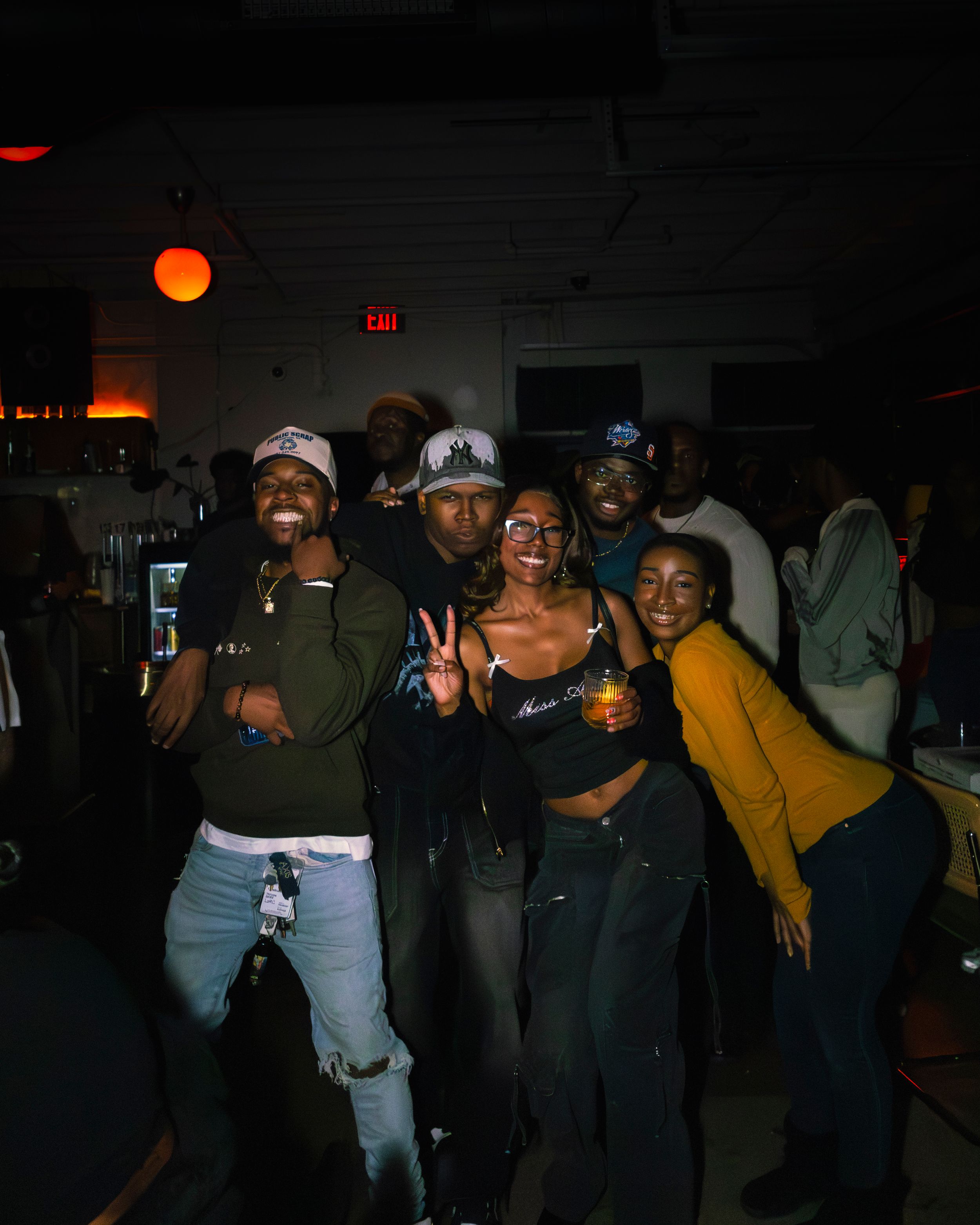 Group gathering at a nighttime social event with warm lighting.