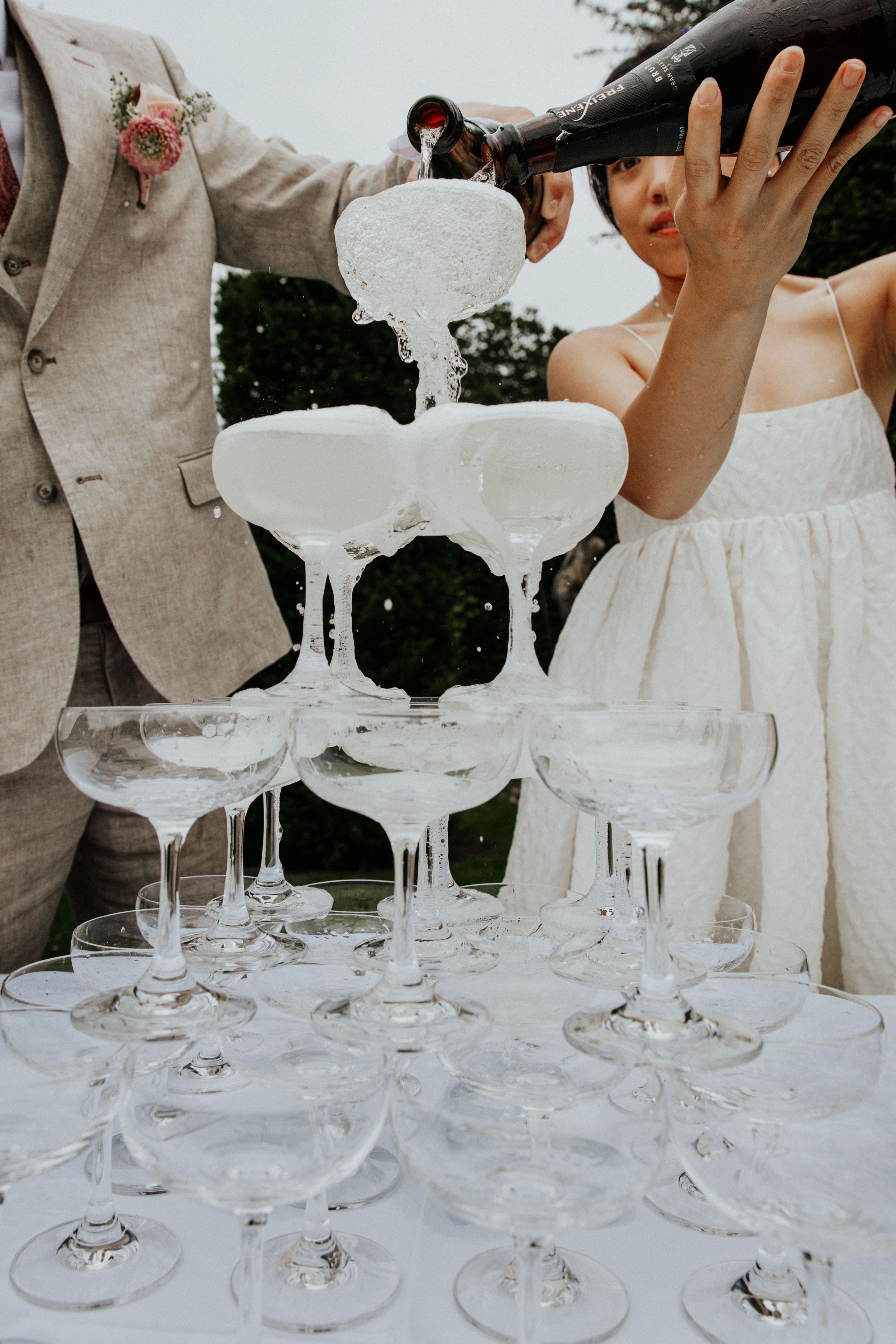 Champagne tower celebration after wedding ceremony at Nymans Gardens