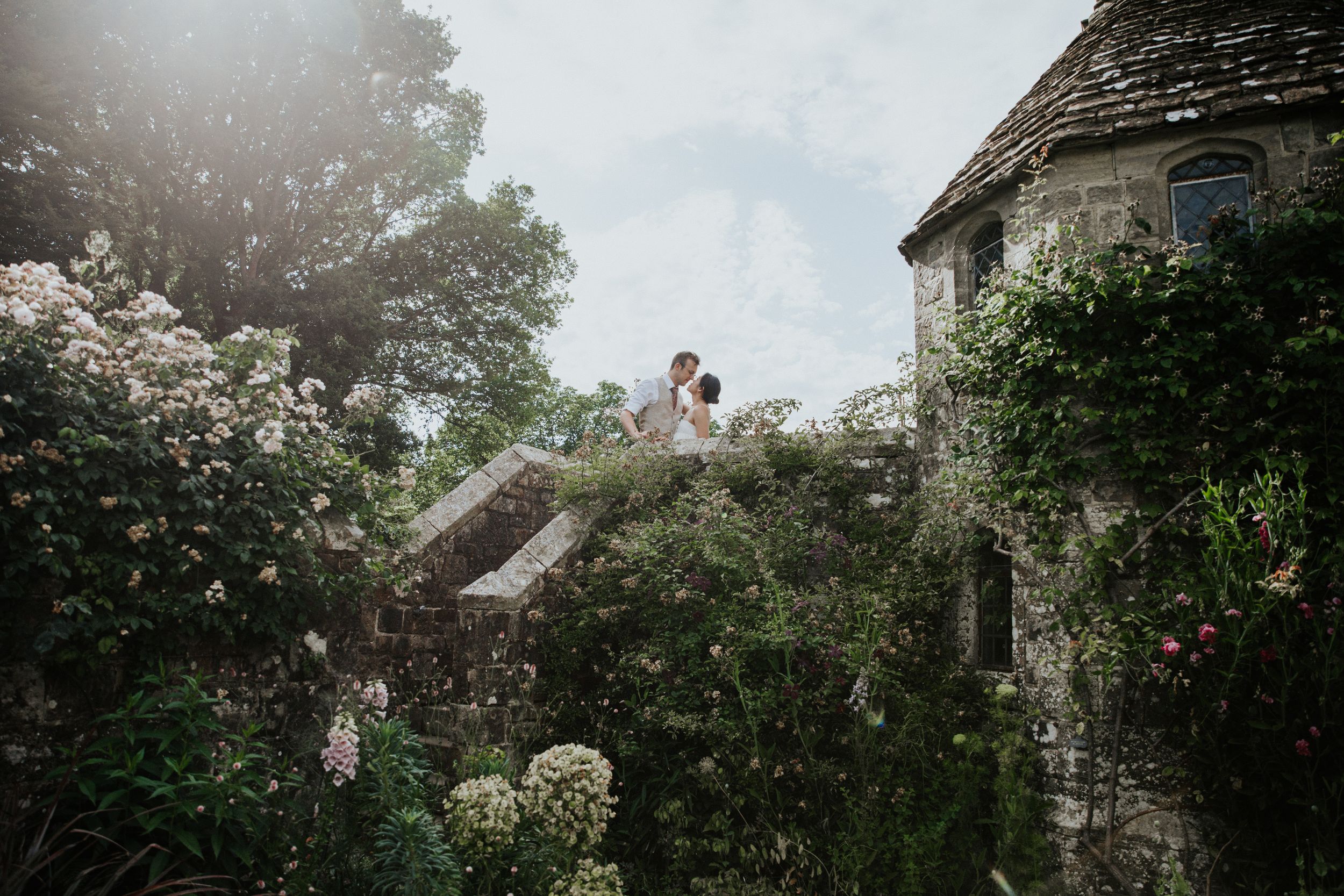 Couple portraits surrounded by greenery at Nymans Gardens National Trust
