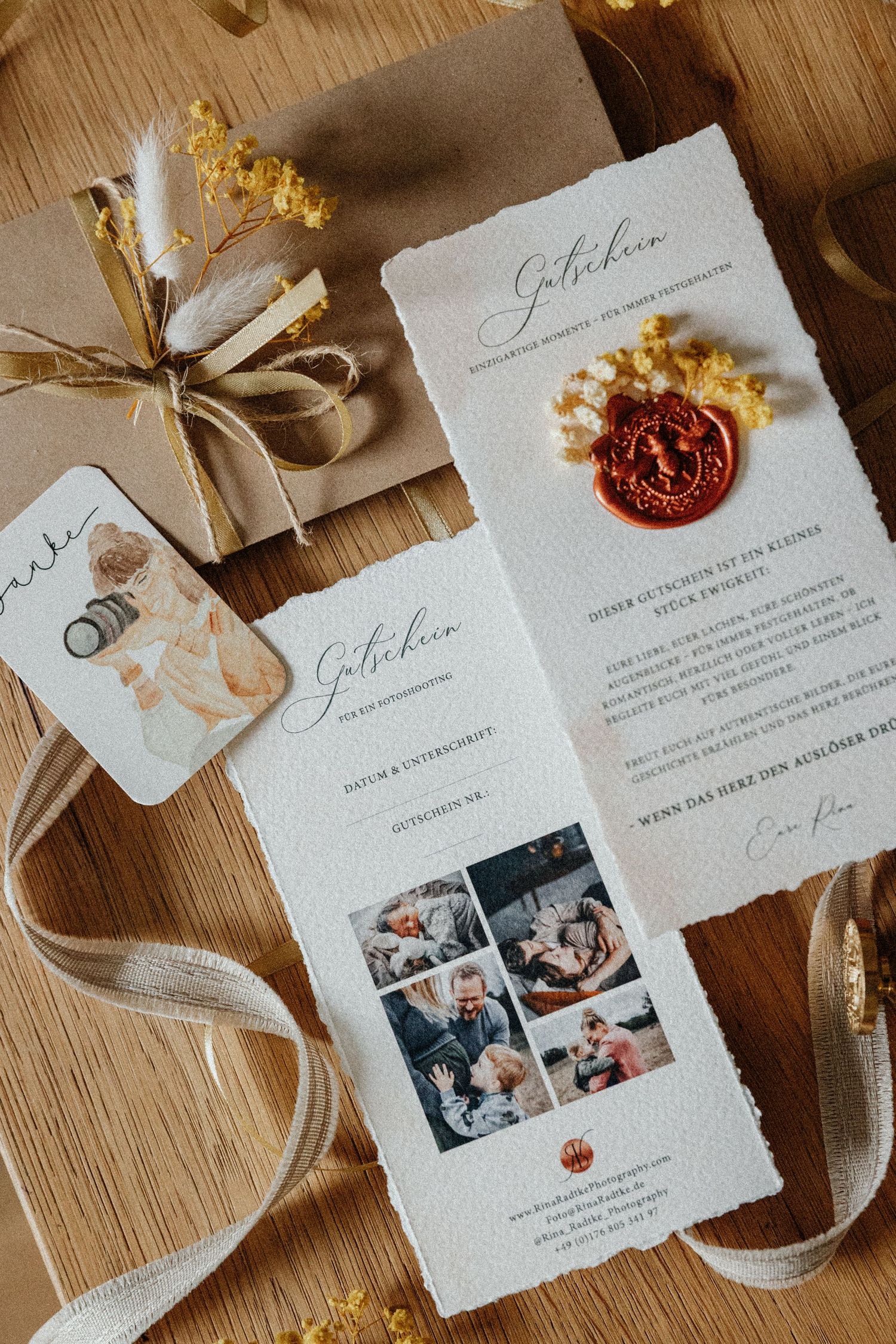 Wedding invitation suite with handmade paper, wax seals, and dried flowers laid out on a wooden surface.