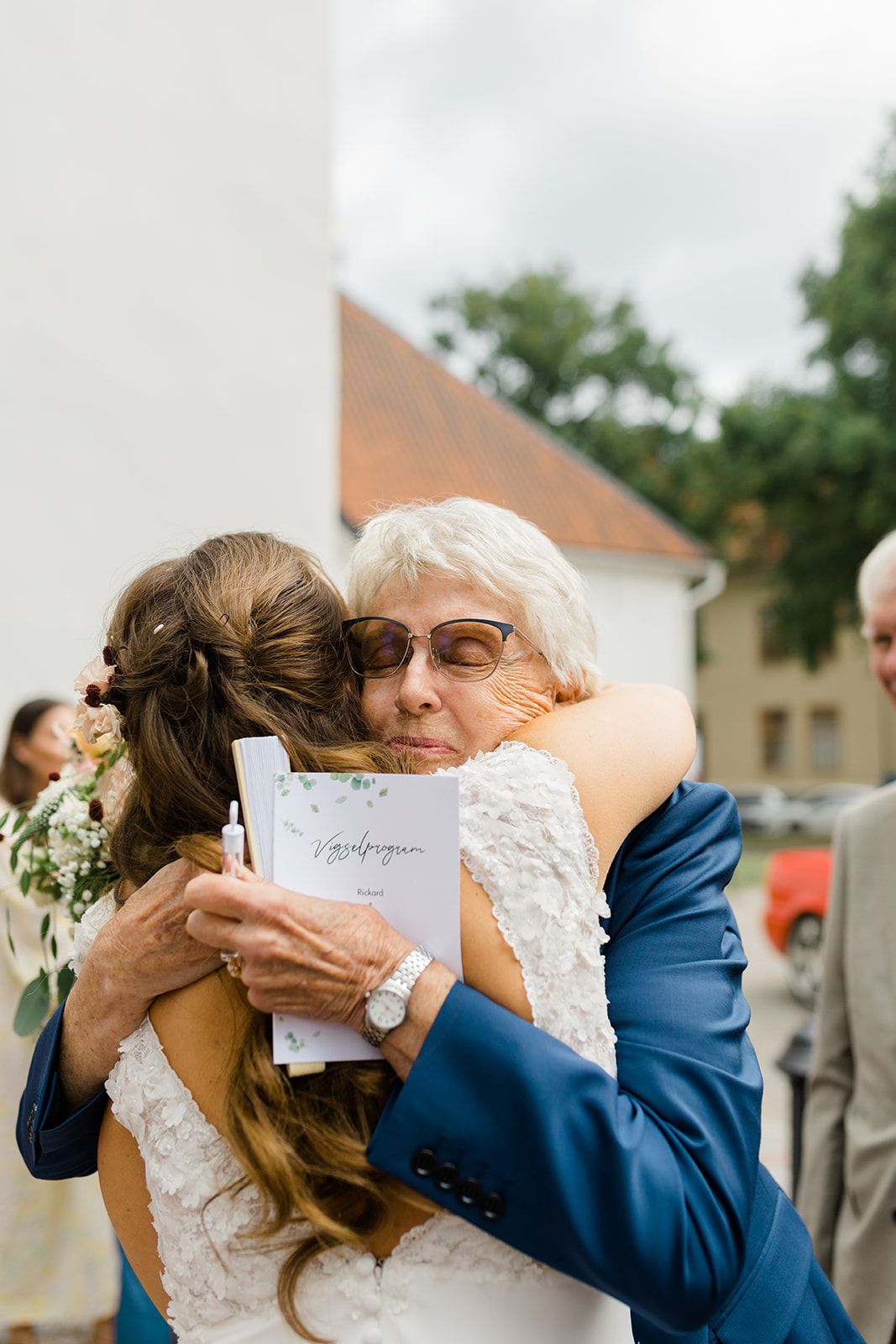 A series of emotional embraces captured in sequence during an outdoor wedding celebration.