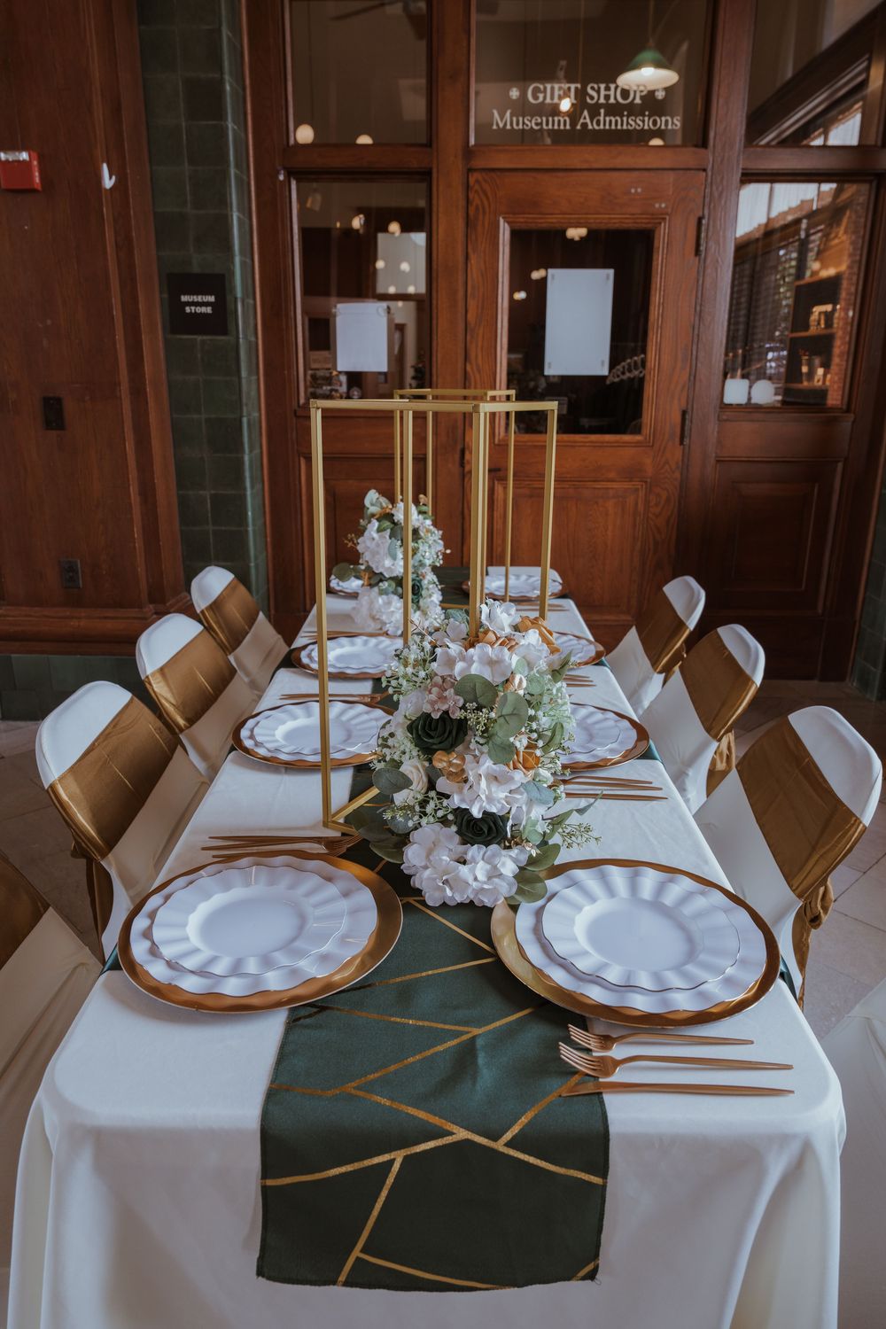 Elegant wedding reception tables set with white linens and floral centerpieces.