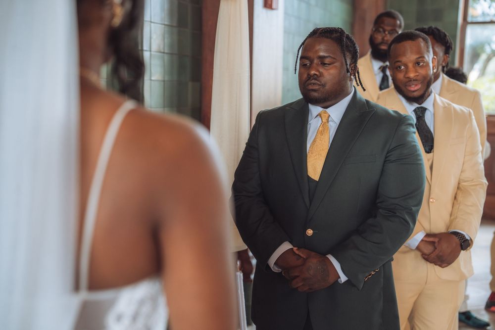 Wedding ceremony participants standing at the altar in formal attire.