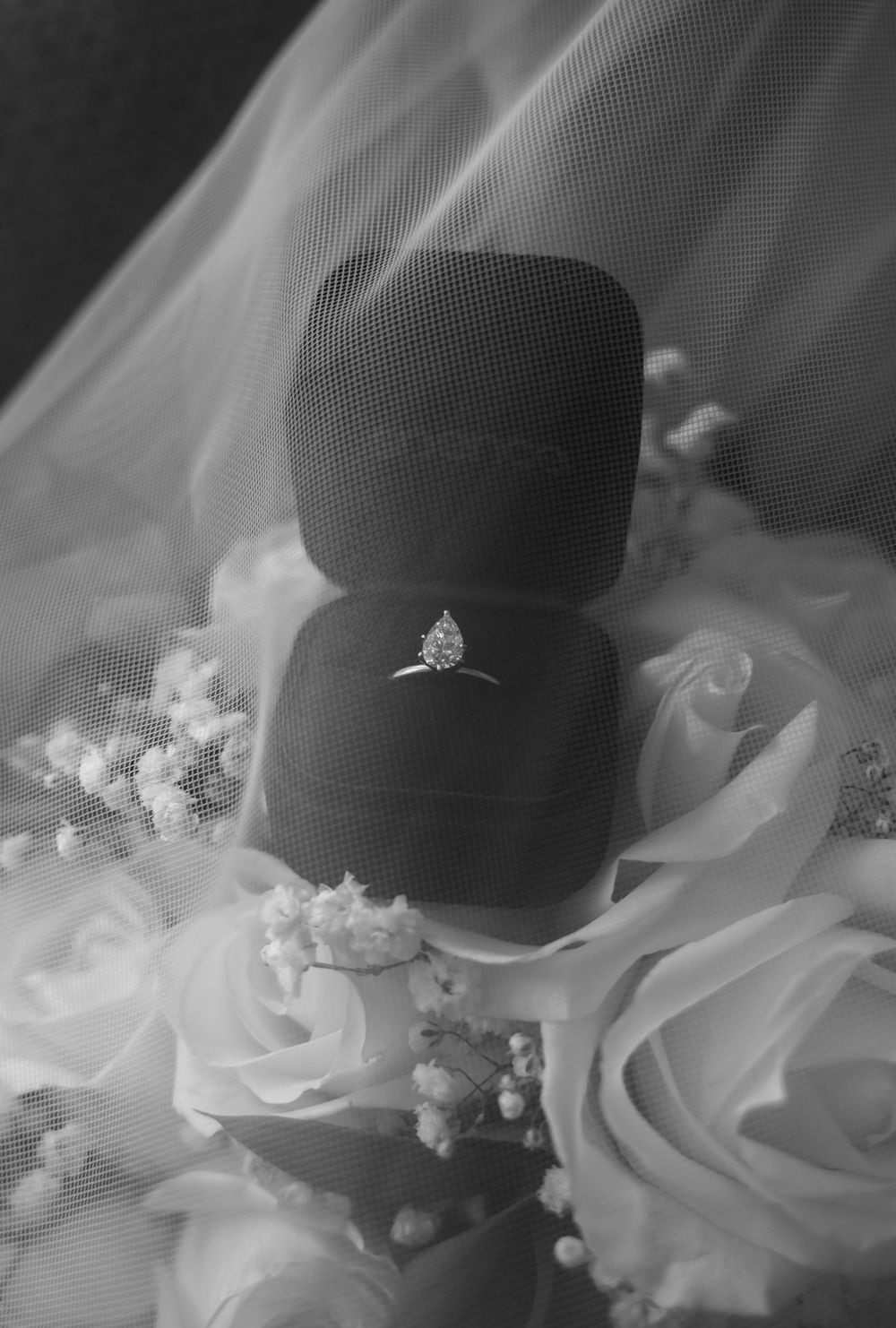 Close-up detail of delicate white lace and tulle from a wedding dress.