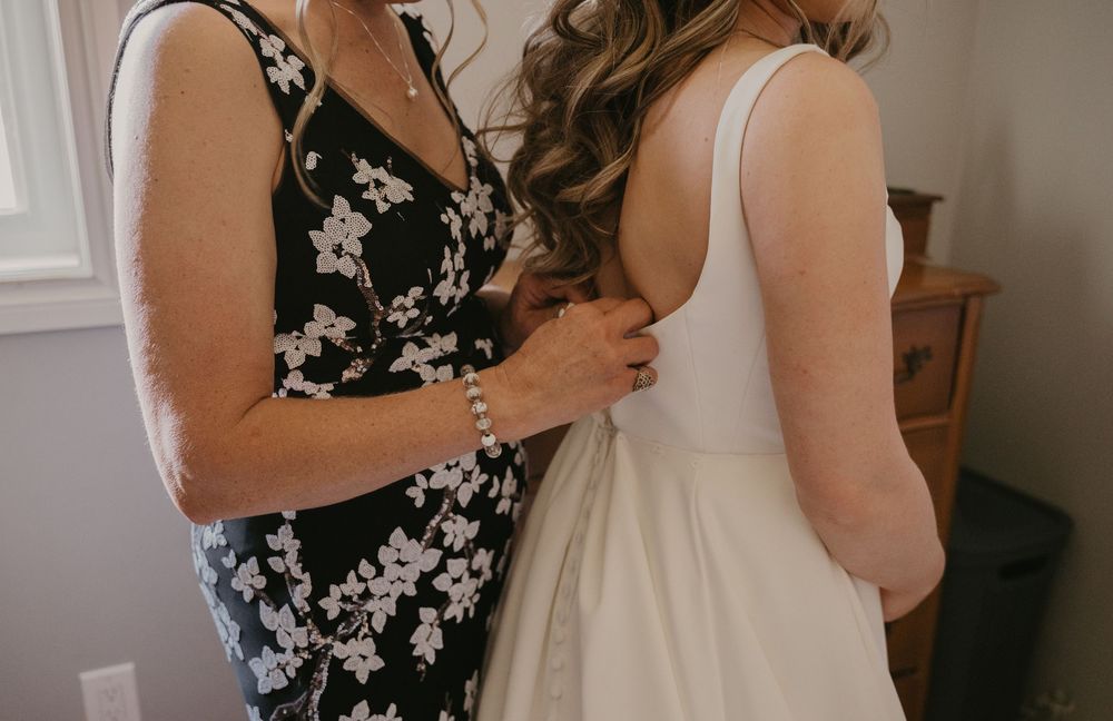 Close-up view of formal dresses with floral patterns and white fabric details.