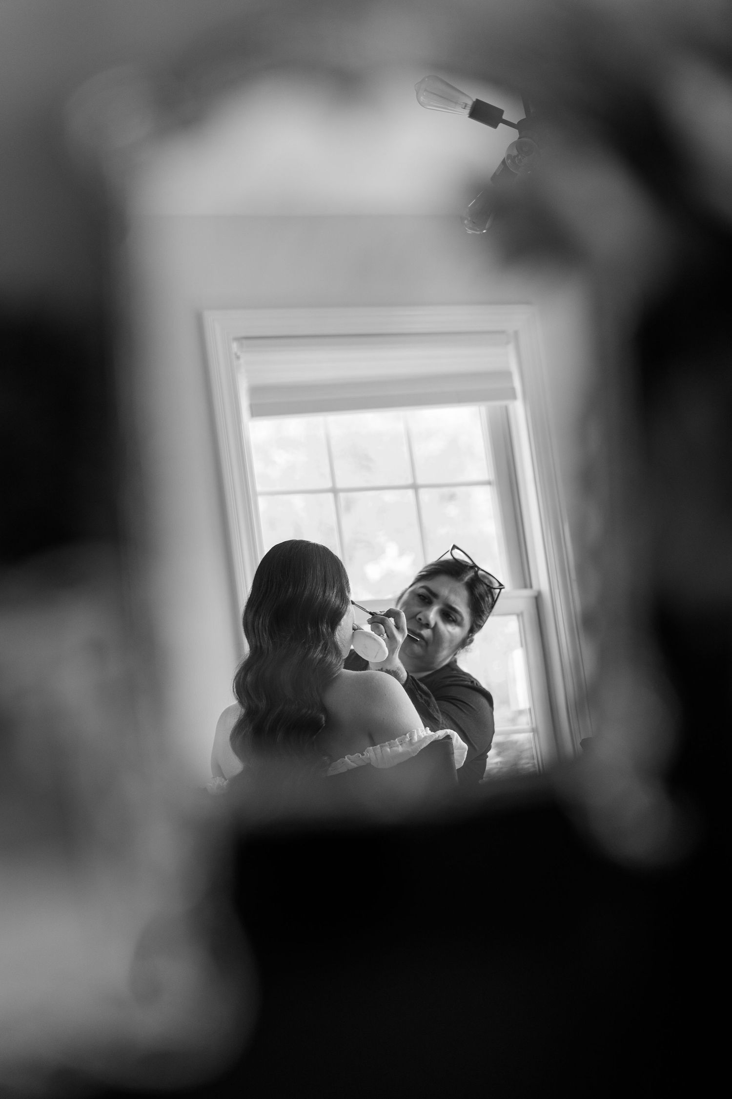A series of black and white photos showing silhouettes near a window in different poses and angles.